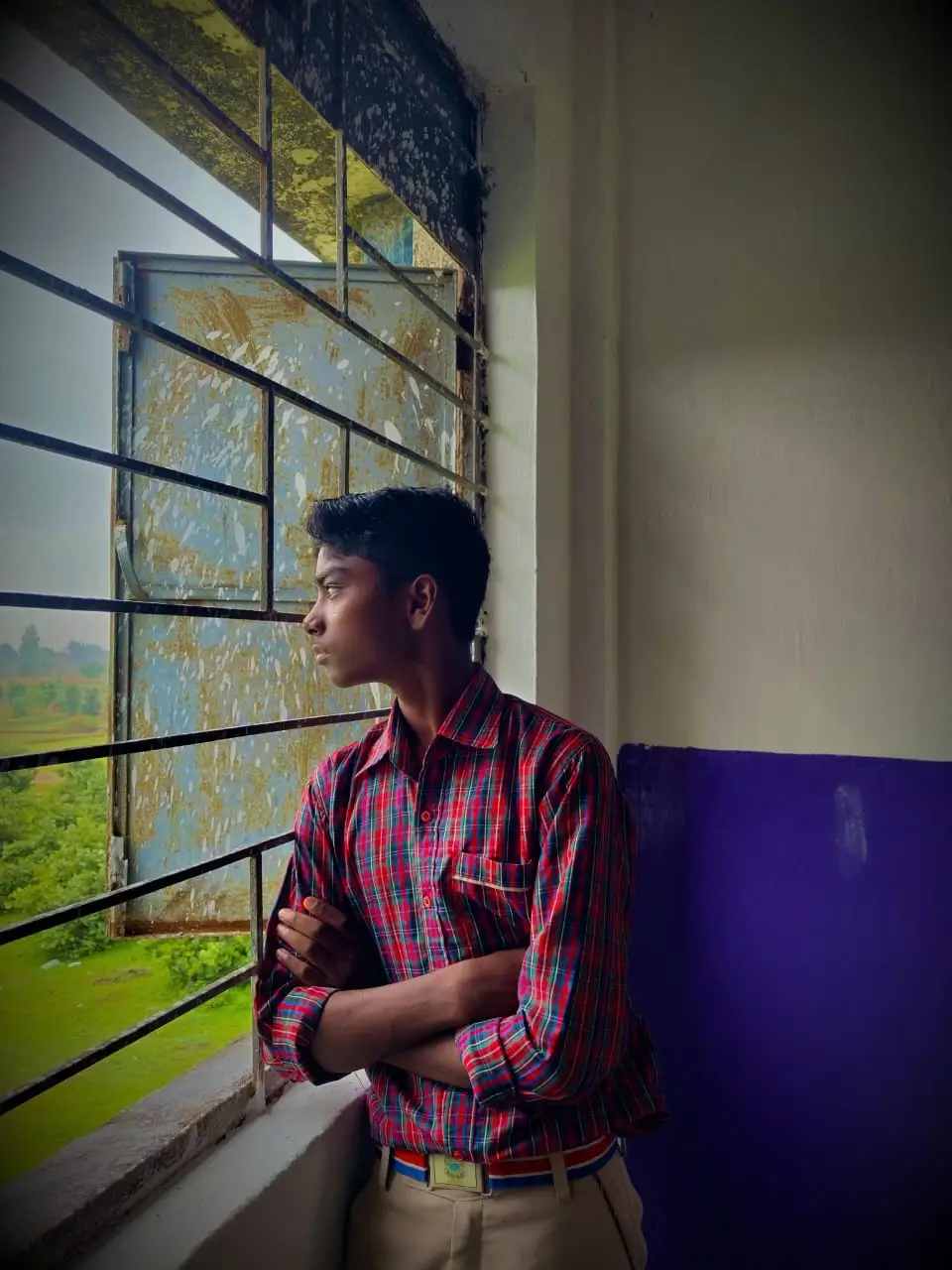 Aditya Kumar Ekka looking out the window at DAV school — thinking about code and the future